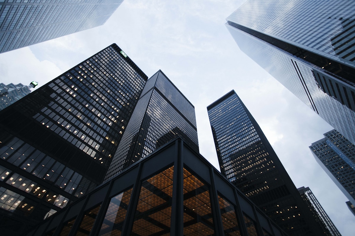 Modern glass office towers against a dramatic sky